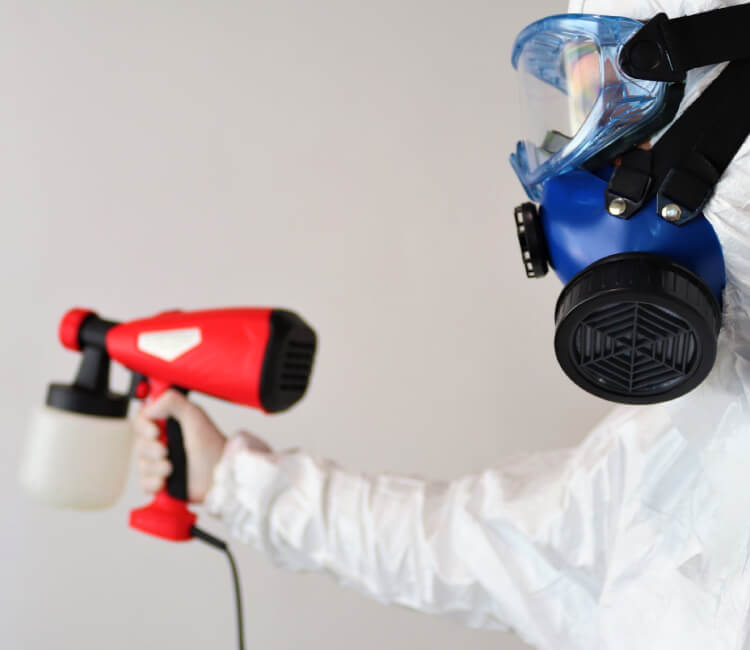 man in white suit removing mold